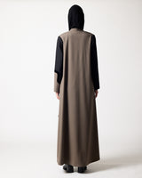 A person shown from the back wearing a long, loose abaya or dress in taupe-brown with contrasting black sleeves and a black headscarf, standing against a plain light gray studio background.عبايات خليجية فخمة | Luxury Gulf Abayas
عبايات فاخرة الخليج | Luxury Abayas Gulf
عبايات مصممين الخليج | Designer Abayas Gulf
عبايات راقية الدوحة | Elegant Abayas Doha
عبايات فخمة الدوحة | Luxury Abayas Doha
عبايات فاخرة الدوحة | Premium Abayas Doha
عبايات قطر والخليج | Qatar & Gulf Abayas
عبايات اونلاين الخليج | Abayas On