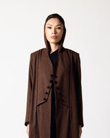 A model wearing a long, dark brown hooded coat with large black buttons down the front, styled over a black top, set against a plain light gray background.عبايات قطر | Abaya Qatar
عبايات الدوحة | Abayas Doha
عباية قطر | Abaya Doha
عبايات اونلاين قطر | Abayas Online Qatar
عبايات أونلاين قطر | Online Abayas Qatar
شراء عبايات قطر | Buy Abaya Qatar
شراء عبايات اونلاين | Buy Abayas Online
متجر عبايات قطر | Abaya Store Qatar
محل عبايات قطر | Abaya Shop Qatar
بوتيك عبايات قطر | Abaya Boutique Qatar
عبايات نسائية ق