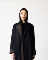 A model wearing a long black coat with contrasting dark brown panels on the front and cuffs, styled with a black hood, against a plain light gray background.عبايات قطر | Abaya Qatar
عبايات الدوحة | Abayas Doha
عباية قطر | Abaya Doha
عبايات اونلاين قطر | Abayas Online Qatar
عبايات أونلاين قطر | Online Abayas Qatar
شراء عبايات قطر | Buy Abaya Qatar
شراء عبايات اونلاين | Buy Abayas Online
متجر عبايات قطر | Abaya Store Qatar
محل عبايات قطر | Abaya Shop Qatar
بوتيك عبايات قطر | Abaya Boutique Qatar
عبايات نسائية